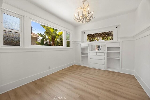 1111 Dawson Ave, Long Beach, CA 90804 - unfurnished dining area featuring a chandelier and light wood-style flooring