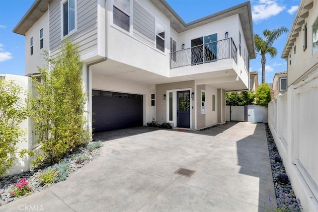2117 Marshallfield Ln Unit B, Redondo Beach, CA 90278 - view of front facade with a balcony, a garage, stucco siding, and concrete driveway