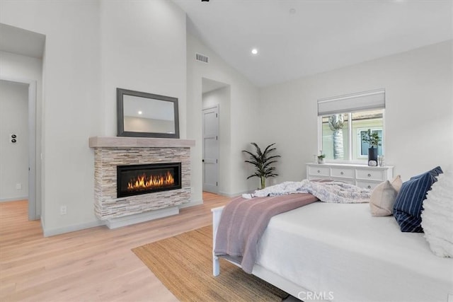 2117 Marshallfield Ln Unit B, Redondo Beach, CA 90278 - bedroom with light wood-type flooring, a stone fireplace, recessed lighting, and high vaulted ceiling