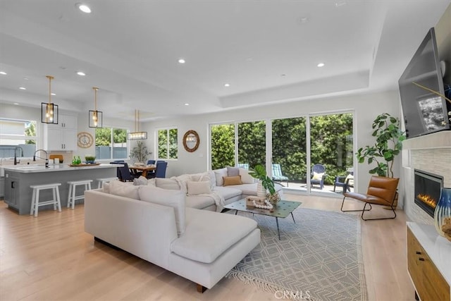 2117 Marshallfield Ln Unit B, Redondo Beach, CA 90278 - living area with light wood-style flooring, healthy amount of natural light, a glass covered fireplace, and recessed lighting