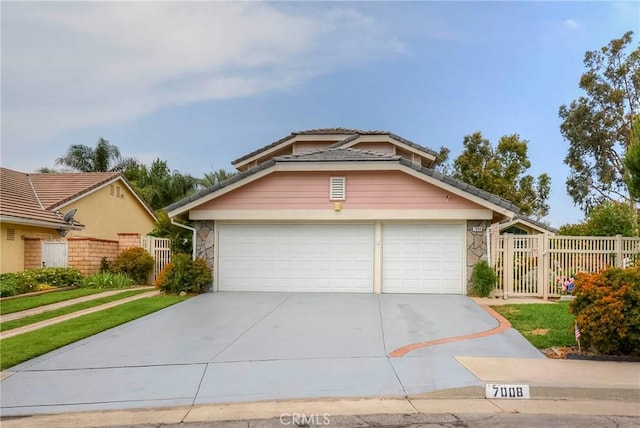 7008 Davenport Ct, Rancho Cucamonga, CA 91701 - view of front of property featuring driveway, stone siding, and an attached garage