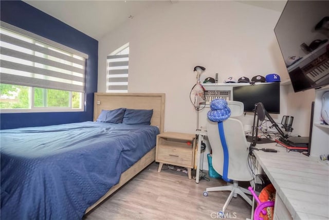 7008 Davenport Ct, Rancho Cucamonga, CA 91701 - bedroom with vaulted ceiling, wood finished floors, and a desk