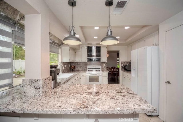 7008 Davenport Ct, Rancho Cucamonga, CA 91701 - kitchen with white appliances, tasteful backsplash, a peninsula, light stone countertops, and recessed lighting