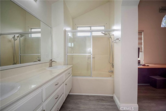 7008 Davenport Ct, Rancho Cucamonga, CA 91701 - bathroom featuring wood finished floors, shower / bath combination with glass door, double vanity, and lofted ceiling