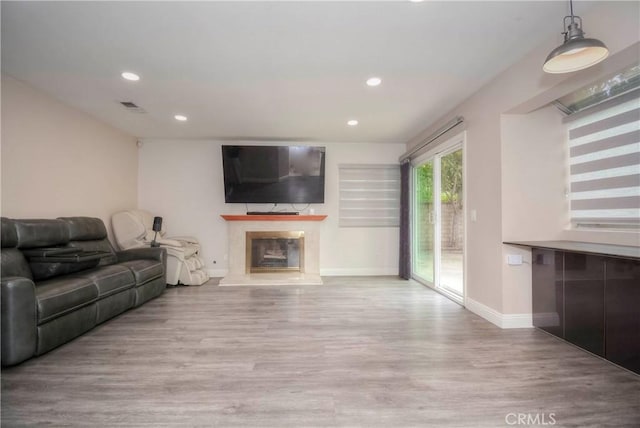 7008 Davenport Ct, Rancho Cucamonga, CA 91701 - living area featuring wood finished floors, a high end fireplace, and recessed lighting