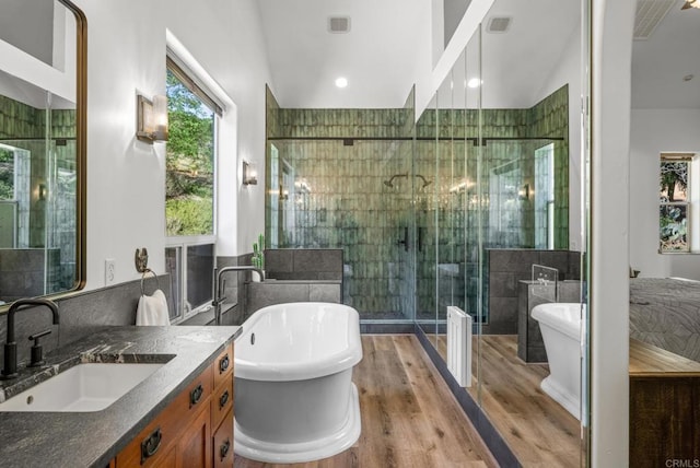 26380 San Felipe Rd, Warner Springs, CA 92086 - full bathroom featuring vanity, a stall shower, wood finished floors, a freestanding tub, and tile walls