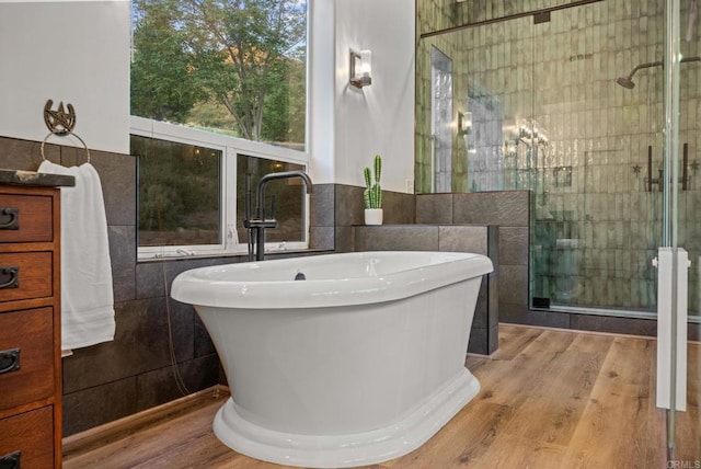 26380 San Felipe Rd, Warner Springs, CA 92086 - bathroom with a soaking tub, tile walls, wood finished floors, and a stall shower
