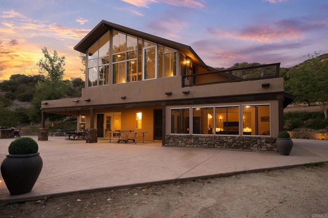 26380 San Felipe Rd, Warner Springs, CA 92086 - back of property at dusk featuring a patio area, a balcony, and stucco siding