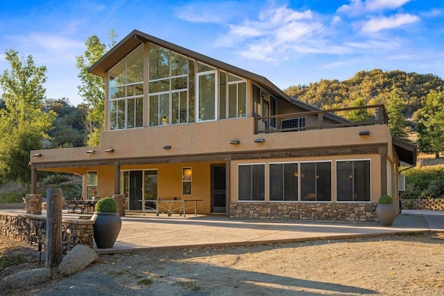 26380 San Felipe Rd, Warner Springs, CA 92086 - back of property featuring a patio area, stone siding, stucco siding, a sunroom, and a balcony