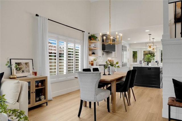 637 Silver Bridle Rd, Walnut, CA 91789 - dining space with a chandelier, light wood-style floors, recessed lighting, beverage cooler, and a towering ceiling
