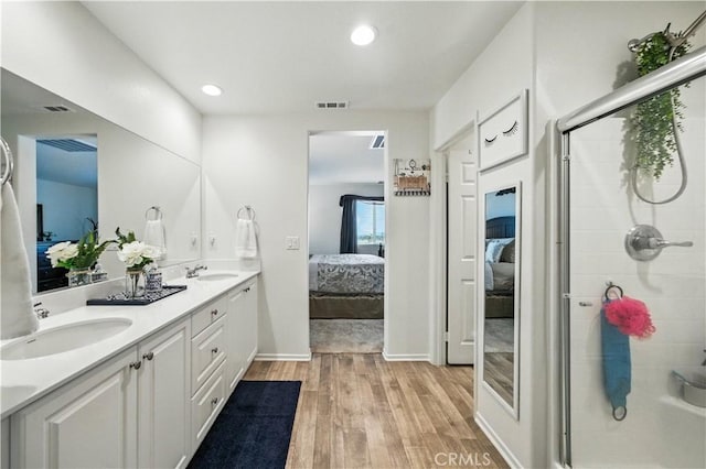 14160 Hercules St, Hesperia, CA 92345 - ensuite bathroom featuring double vanity, wood finished floors, a tile shower, and recessed lighting