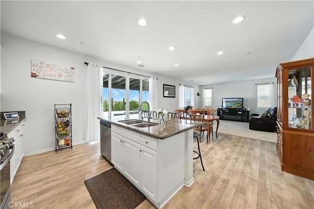 14160 Hercules St, Hesperia, CA 92345 - kitchen featuring appliances with stainless steel finishes, an island with sink, recessed lighting, white cabinetry, and a kitchen bar