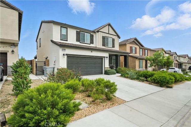 14160 Hercules St, Hesperia, CA 92345 - view of property with an attached garage, driveway, stucco siding, a residential view, and a gate
