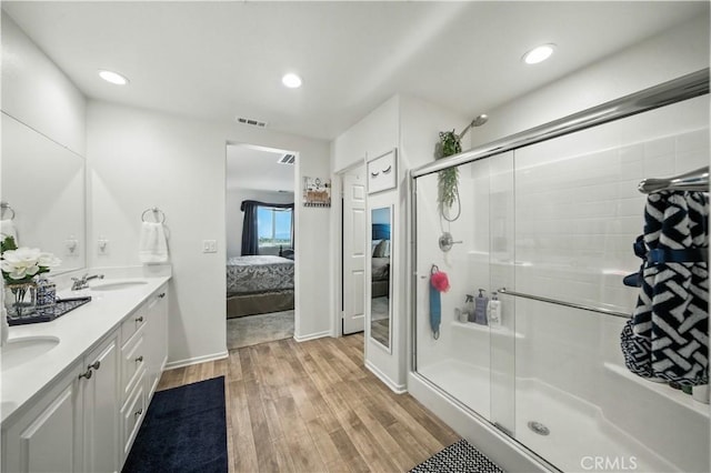 14160 Hercules St, Hesperia, CA 92345 - ensuite bathroom with double vanity, wood finished floors, a stall shower, and recessed lighting