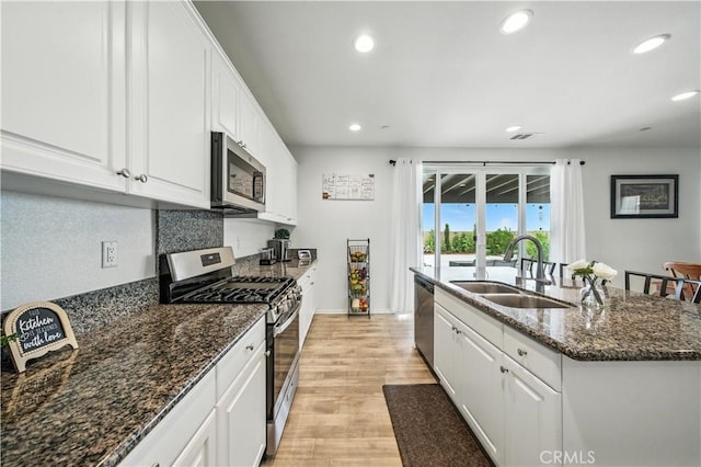 14160 Hercules St, Hesperia, CA 92345 - kitchen featuring stainless steel appliances, an island with sink, light wood-style floors, recessed lighting, and white cabinetry