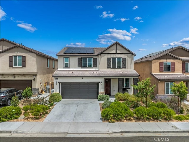 14160 Hercules St, Hesperia, CA 92345 - view of front facade with an attached garage, solar panels, stucco siding, driveway, and covered porch