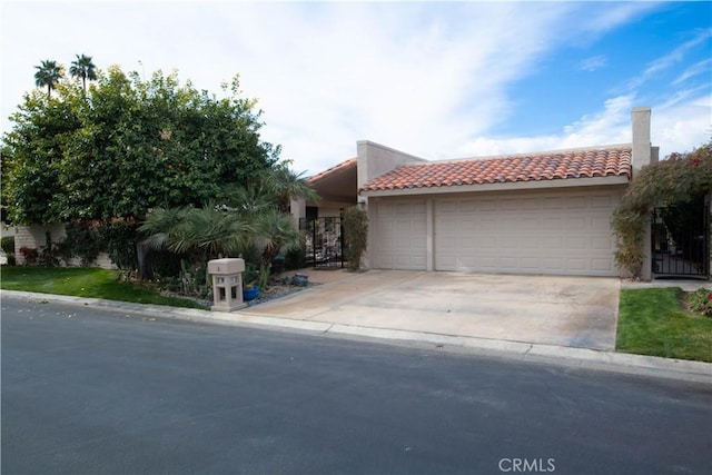 30 Colgate Dr, Rancho Mirage, CA 92270 - view of front of house with a garage, a tiled roof, driveway, and stucco siding