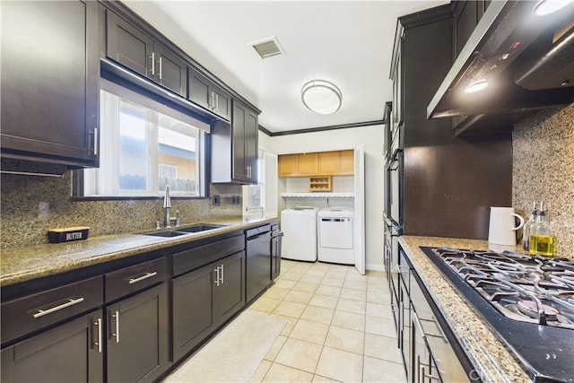 8412 San Marino Dr, Buena Park, CA 90620 - kitchen with independent washer and dryer, ventilation hood, black appliances, backsplash, and light tile patterned floors