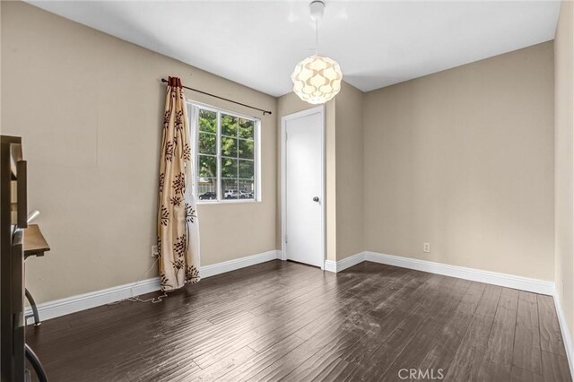 17959 Cantara St, Reseda, CA 91335 - unfurnished room with dark wood-style floors and baseboards