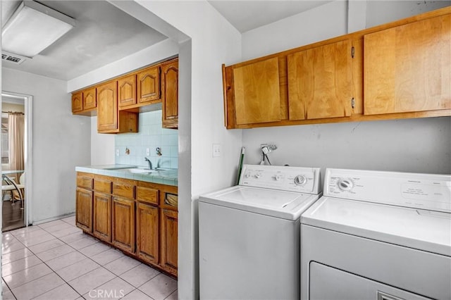 17959 Cantara St, Reseda, CA 91335 - washroom with washer and dryer, light tile patterned flooring, and cabinet space
