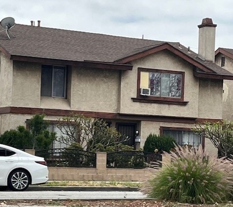 2774 Santa Fe Ave, Long Beach, CA 90810 - townhome / multi-family property with stucco siding, a shingled roof, a chimney, and cooling unit