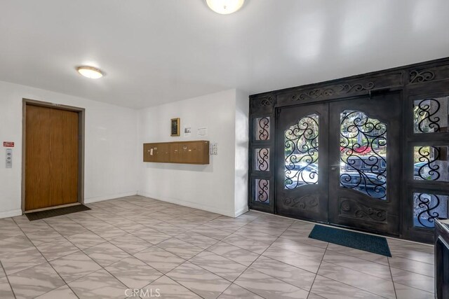 3284 Barham Blvd Unit 201, Los Angeles, CA 90068 - foyer featuring french doors and baseboards