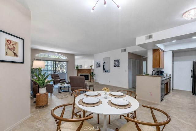 3284 Barham Blvd Unit 201, Los Angeles, CA 90068 - dining space with a fireplace with raised hearth and light tile patterned floors