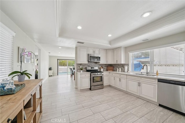 1346 Butler Way, Upland, CA 91786 - kitchen with appliances with stainless steel finishes, a raised ceiling, light countertops, tasteful backsplash, and recessed lighting