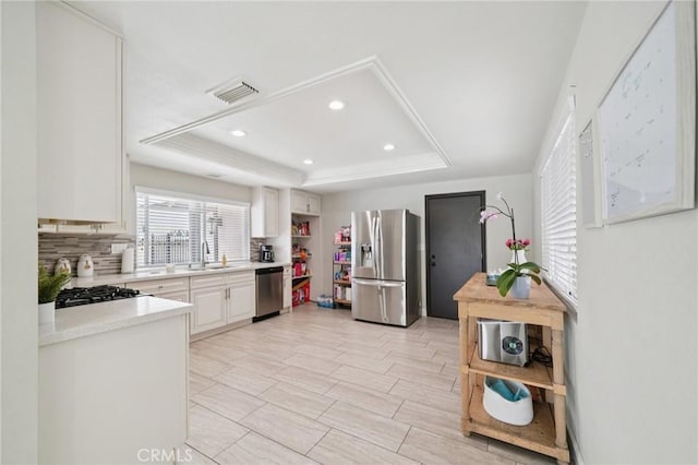 1346 Butler Way, Upland, CA 91786 - kitchen featuring stainless steel appliances, a tray ceiling, light countertops, tasteful backsplash, and recessed lighting