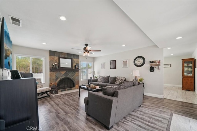 1346 Butler Way, Upland, CA 91786 - living room featuring plenty of natural light, a ceiling fan, a stone fireplace, recessed lighting, and wood finished floors