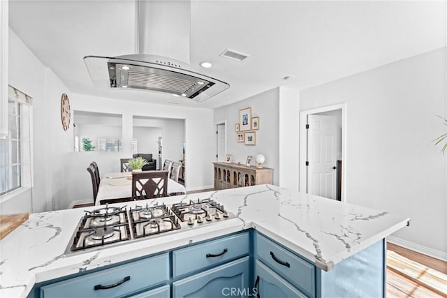 14508 S Corlett Ave, Compton, CA 90220 - kitchen featuring blue cabinetry, stainless steel gas stovetop, light stone counters, light wood-style floors, and recessed lighting