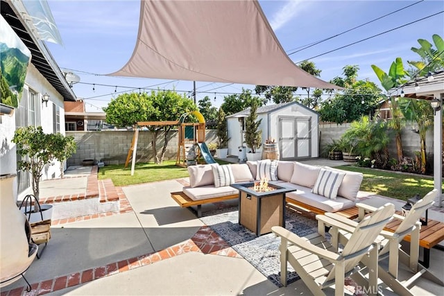 14508 S Corlett Ave, Compton, CA 90220 - fenced backyard featuring a patio, a storage shed, a playground, and an outdoor living space with a fire pit