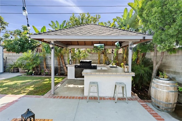 14508 S Corlett Ave, Compton, CA 90220 - fenced backyard with an outdoor kitchen, a gazebo, exterior bar, and a patio