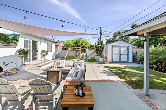 14508 S Corlett Ave, Compton, CA 90220 - view of patio featuring an outdoor fire pit, a storage shed, and a playground