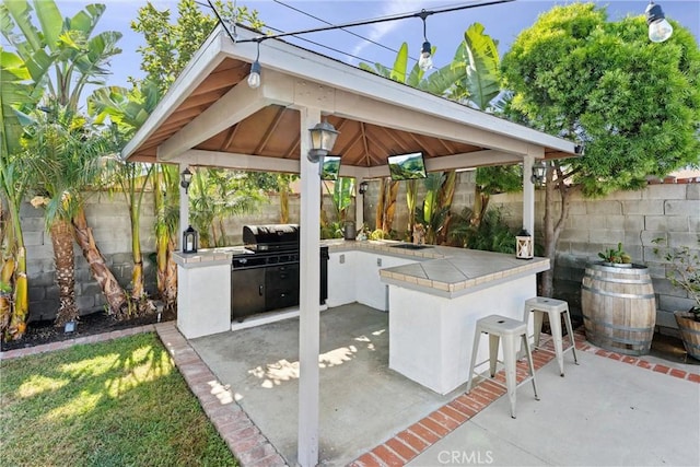 14508 S Corlett Ave, Compton, CA 90220 - fenced backyard featuring a gazebo, an outdoor kitchen, and a patio area