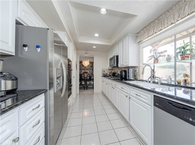 1936 W Cherry Dr, Orange, CA 92868 - kitchen with stainless steel appliances, a raised ceiling, light tile patterned flooring, white cabinets, and dark stone countertops