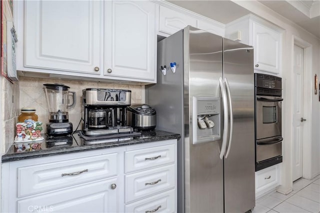 1936 W Cherry Dr, Orange, CA 92868 - kitchen with appliances with stainless steel finishes, a warming drawer, dark stone countertops, and white cabinetry