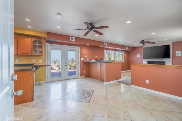 2935 Athel Dr, Hacienda Heights, CA 91745 - kitchen with a ceiling fan, open floor plan, brown cabinets, french doors, and a peninsula