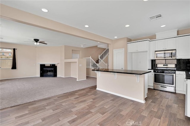 35668 Trevino Trl, Beaumont, CA 92223 - kitchen featuring appliances with stainless steel finishes, white cabinets, a ceiling fan, light wood-style flooring, and recessed lighting