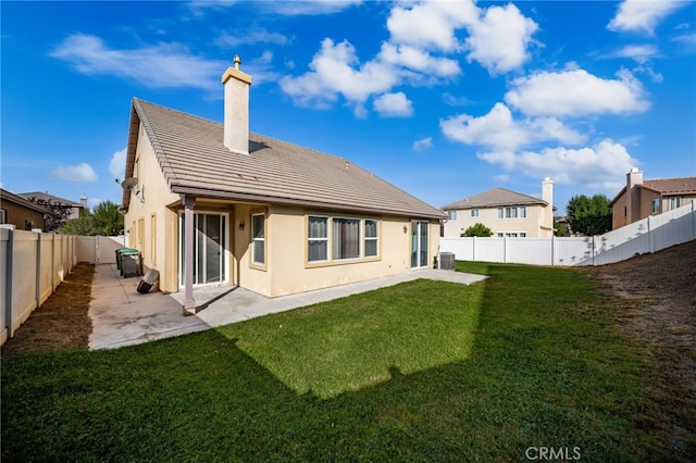 35668 Trevino Trl, Beaumont, CA 92223 - back of house with a chimney, stucco siding, a fenced backyard, a patio, and a tiled roof