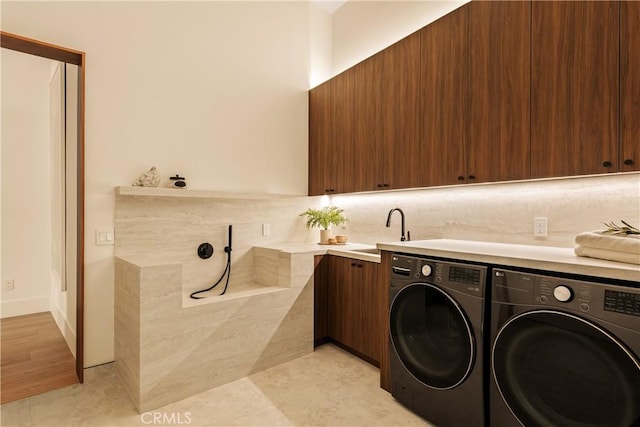1955 Curson Pl, Los Angeles, CA 90046 - washroom featuring washing machine and clothes dryer, cabinet space, and light tile patterned floors