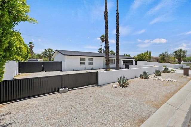 2002 N Whitewater Club Dr N, Palm Springs, CA 92262 - view of front of house featuring a fenced front yard and a gate