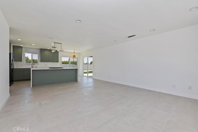 2002 N Whitewater Club Dr N, Palm Springs, CA 92262 - unfurnished living room featuring recessed lighting, light tile patterned flooring, and a chandelier