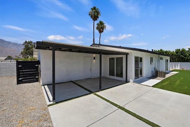 2002 N Whitewater Club Dr N, Palm Springs, CA 92262 - back of property with stucco siding, a mountain view, and a patio