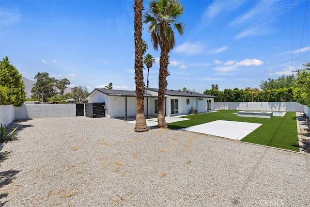 2002 N Whitewater Club Dr N, Palm Springs, CA 92262 - rear view of property featuring a fenced backyard, a patio, and a swimming pool