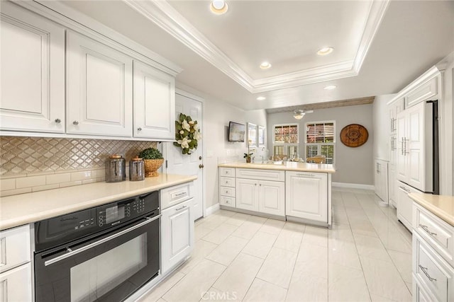 6171 E Morningview Dr, Anaheim, CA 92807 - kitchen with black oven, ornamental molding, decorative backsplash, recessed lighting, and a raised ceiling