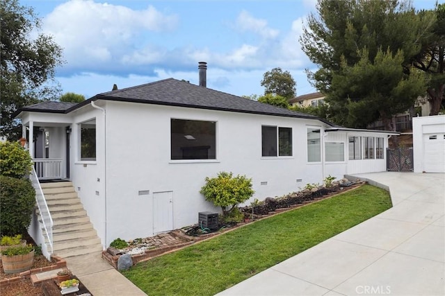 2141 Sierra Way, San Luis Obispo, CA 93401 - view of property exterior featuring a lawn, stucco siding, a shingled roof, concrete driveway, and stairs
