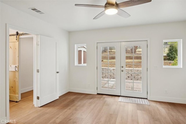 2141 Sierra Way, San Luis Obispo, CA 93401 - doorway with light wood finished floors, ceiling fan, a barn door, and french doors
