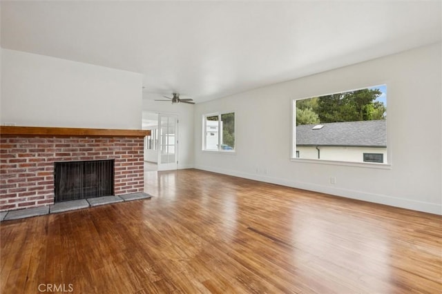 2141 Sierra Way, San Luis Obispo, CA 93401 - unfurnished living room featuring wood finished floors, a brick fireplace, and a ceiling fan