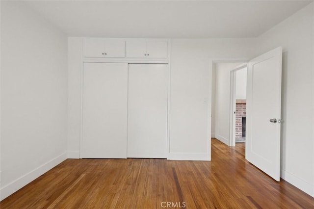 2141 Sierra Way, San Luis Obispo, CA 93401 - unfurnished bedroom featuring wood finished floors and a closet